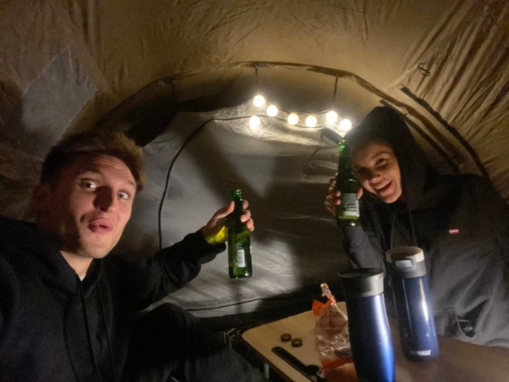 Ludzie z piwem w oświetlonym namiocie
